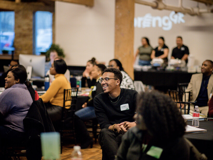 Smiling participants of SpringGR 2020 at class orientation in large open event space